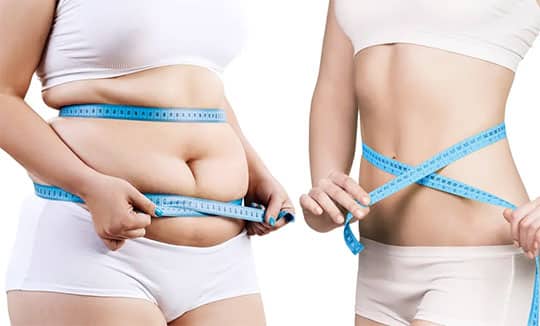 woman measuring stomach before and after weight loss