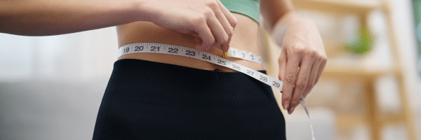 Weight loss results demonstrated by a tape measure around the waist